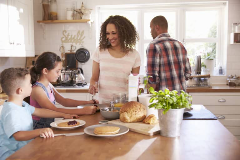 happy family cooking together in the kitchen for a healthier lifestyle